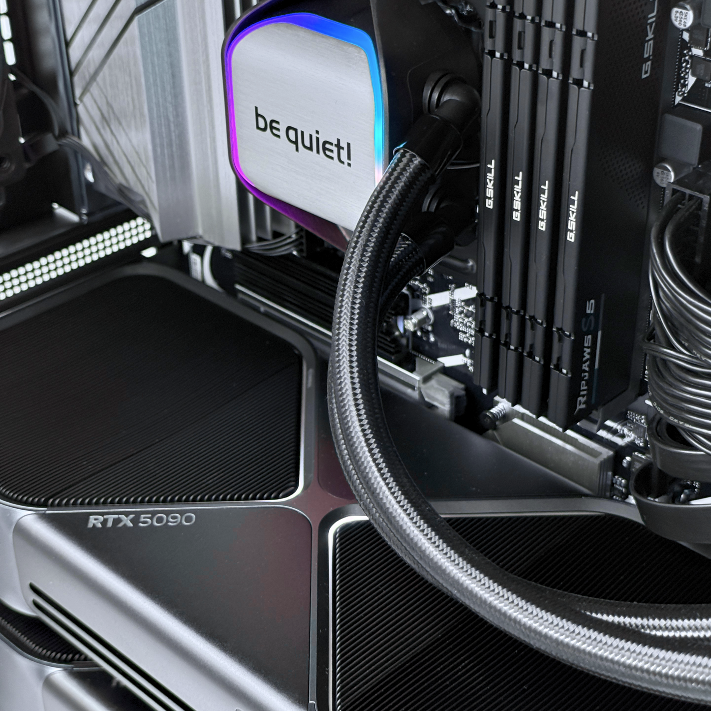 Close-up of computer hardware with 'be quiet!' branding and RTX 5090 graphics card.